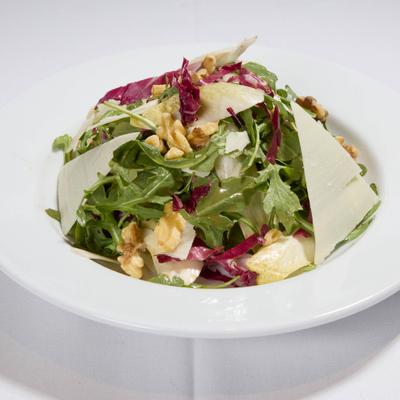 Arugula and endive salad with walnuts and shaved Parmesan.