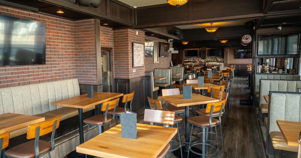 Interior, seating area with leather booths and tables and chairs