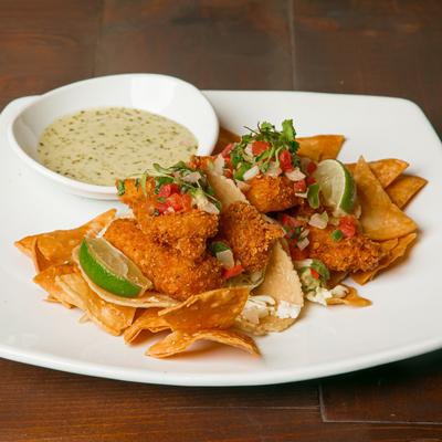 Fried fish tacos with a dressing.