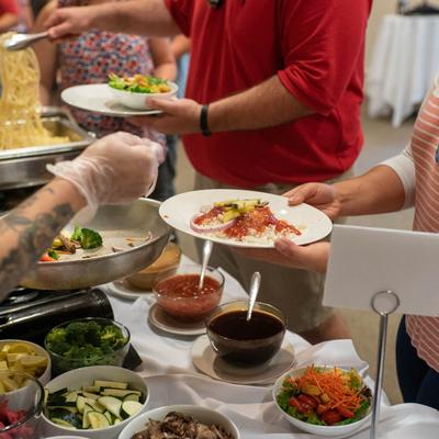 Customers selecting food at the buffet.