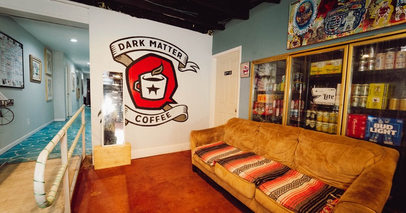 Interior, lounge couch seating, Dark Matter Coffee logo on the wall