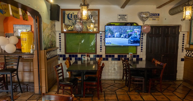 Dining area with tables and TV sets