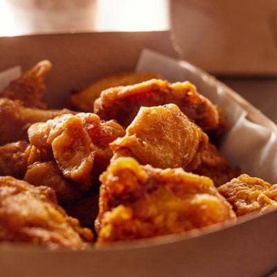 A box filled with crispy fried chicken.