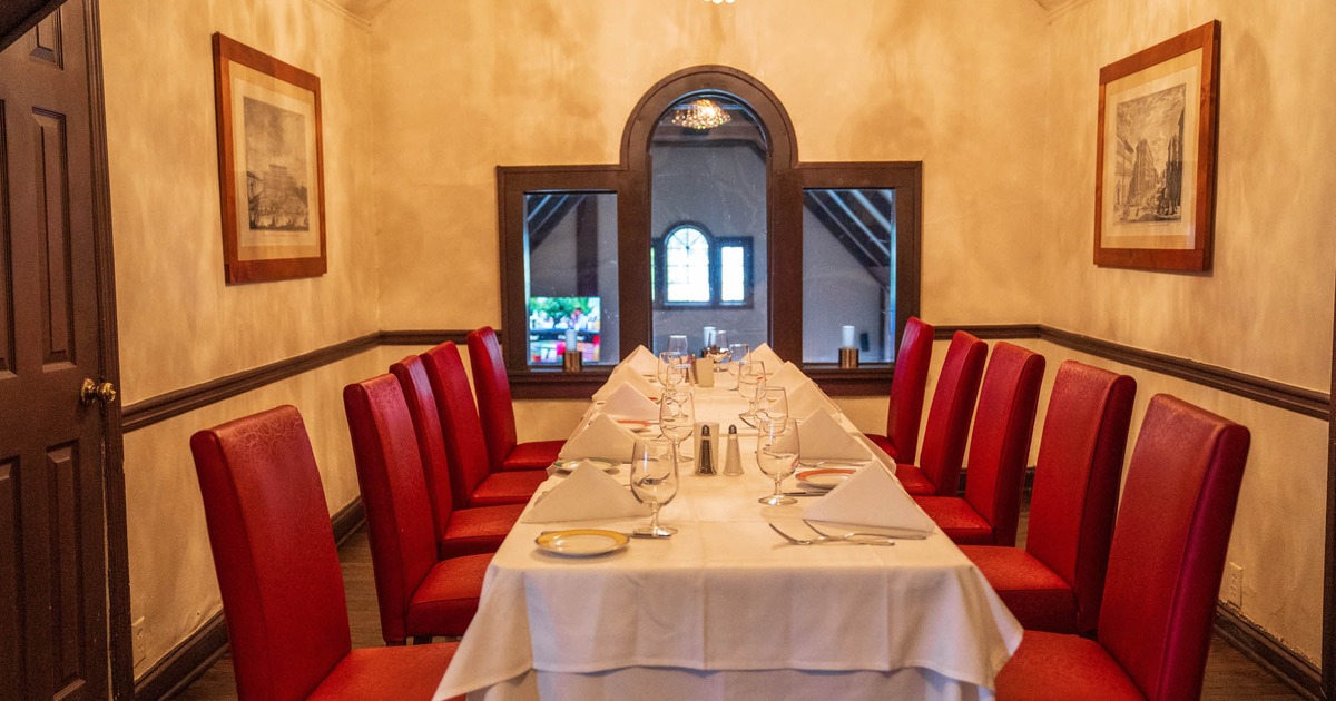 Dining table and red vinyl chairs