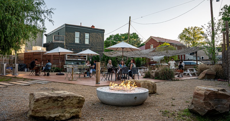 Outdoor seating area with guests, fire pit