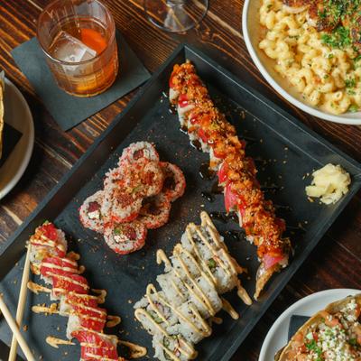 Assorted sushi rolls on tray.