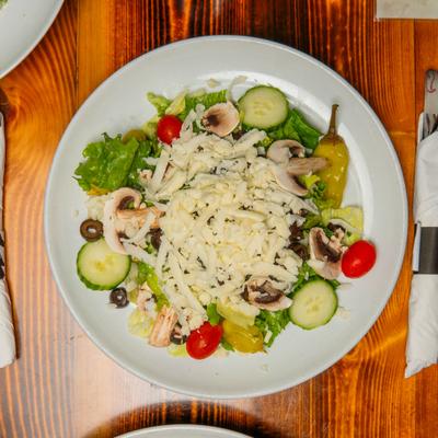 Italian Garden Salad with mushrooms, tomatoes, cheese, and black olives.
