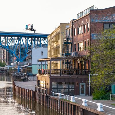 Industrial-style building featuring a large outdoor patio area right on the water.