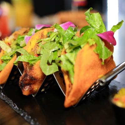 Venezuelan empanadas with shredded chicken, passion fruit pico, guac, and lettuce.