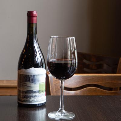 A bottle and glass of red wine