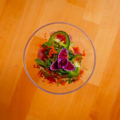 Tuna Martini apperizer topped with jalapeno slices and garnished with a flower.