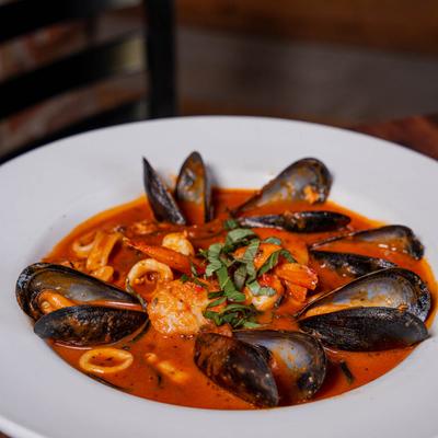 Mussels in a red sauce.