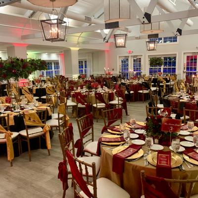 Elegant banquet hall with burgundy table decor.