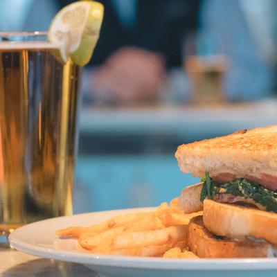 Bacon gouda grilled cheese dish served with a drink