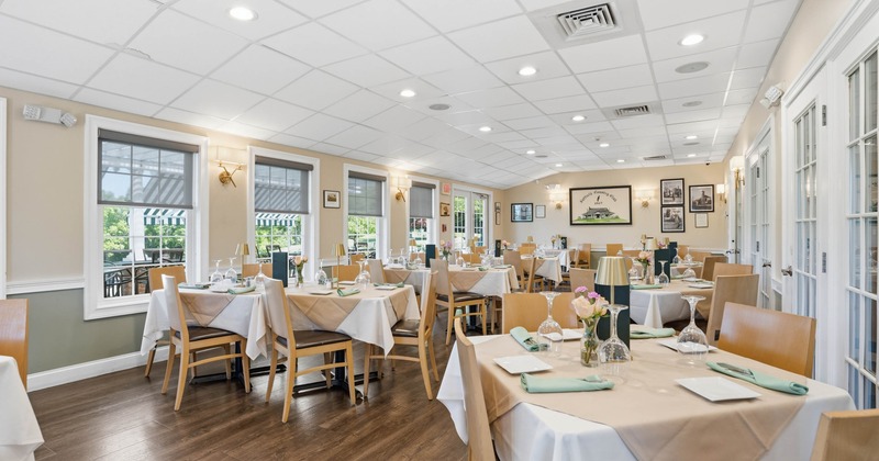 A bright dining room with tables set for guests