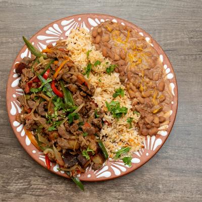 Ranchero steak served with rice and refired beans.