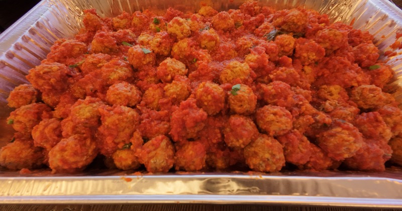 Meatballs in tomato sauce in a metal tray