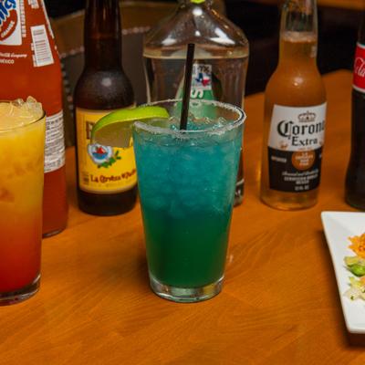 Blue cocktail and various bottled drinks.