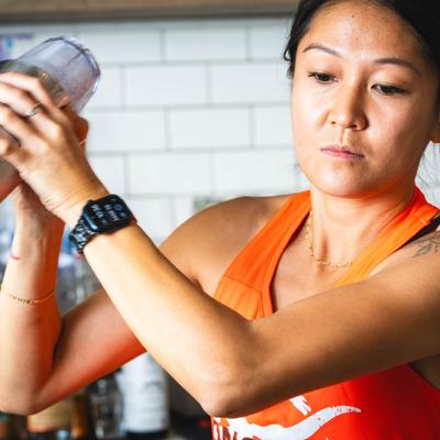 A bartender shaking a cocktail.