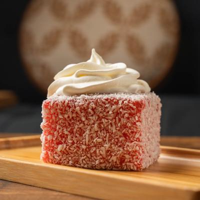 Strawberry cream cake, dusted with coconut flakes.