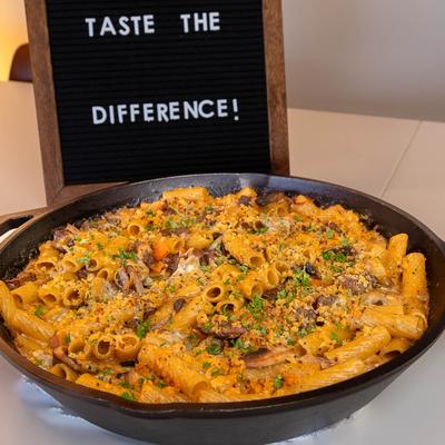 Steak Rigatoni Pasta with creamy garlic sauce, sauteed mushrooms, onion, and tomatoes.