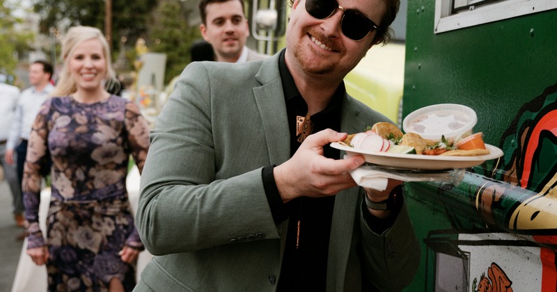 Customer waiting to be served in front of Tres Jardines food truck