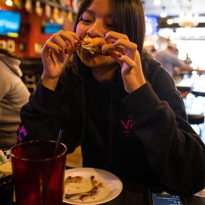 Female guests enjoying chicken wings