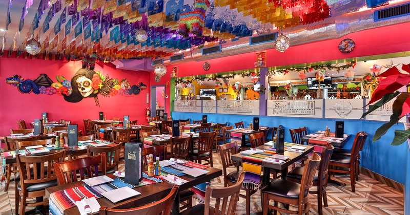 Interior, tables and chairs ready for guests, wall art