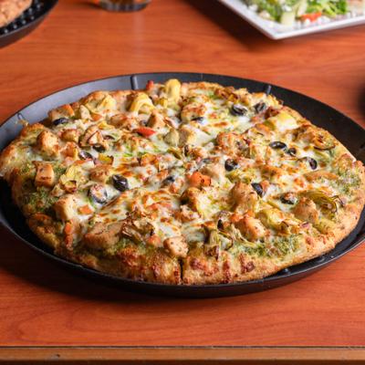 Pesto Supreme Pizza with olives, artichoke harts and grilled chicken.