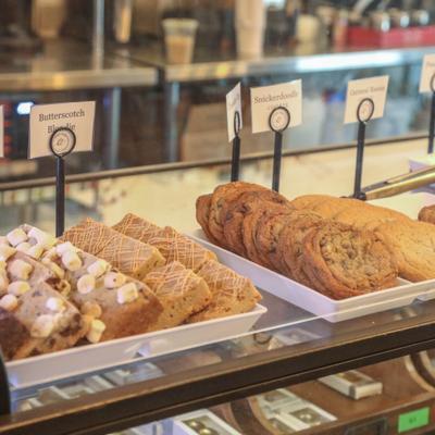 Bakery counter featuring various types of dessert bars and cookies.