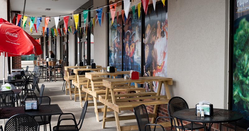 Exterior, patio with tables, chairs and bench seating