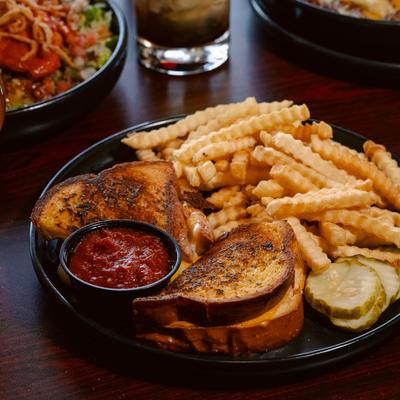 Garlic grilled cheese served with marinara sauce,  fries and pickles.