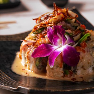 Zenor Pico Roll topped with yellowtail, pico de gallo, crispy onions and a flower.