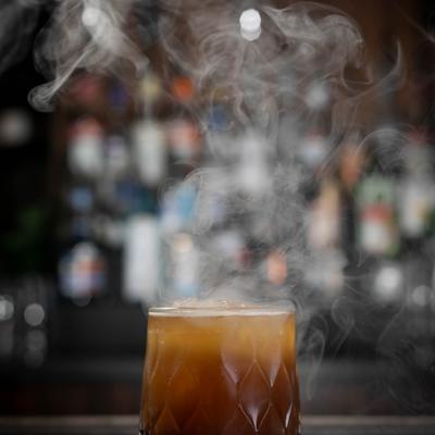 Cocktail served in a rocks glass with a smoking effect.