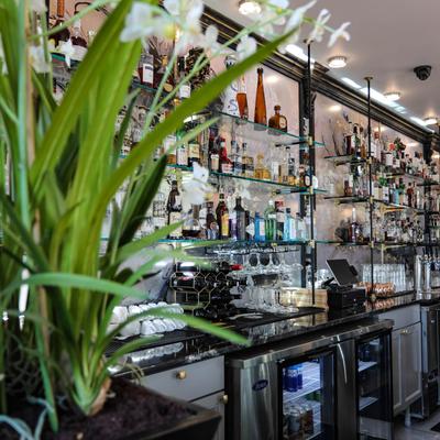 Interior, working area, assorted glasses, cups and bottles on the shelves