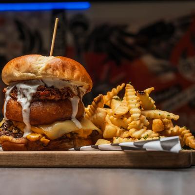 Cheeseburger with onion ring, BBQ pulled pork, ranch, and fries.