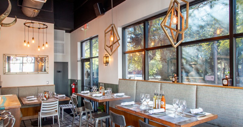 Modern and cozy restaurant interior dining area with set tables ready for guests