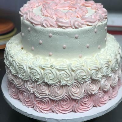 Pink and white rosette frosted cake.