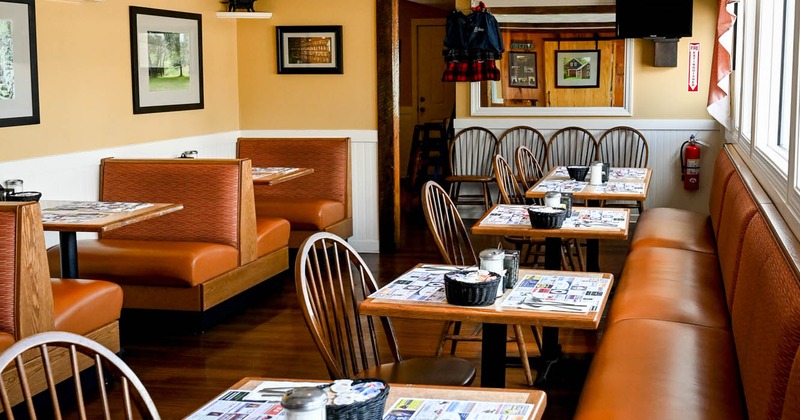 Interior, tables, chairs and seating benches ready for guests