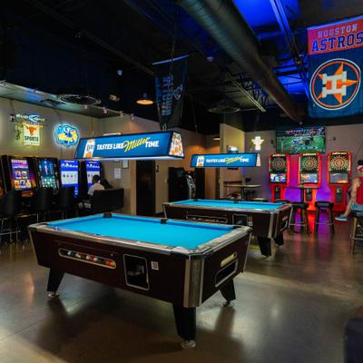 Pool tables in an arcade room.