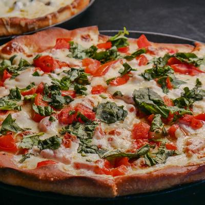 Margherita pizza with melted cheese and fresh basil.