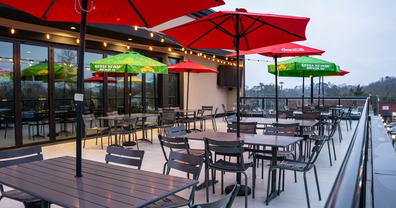Exterior, terrace, partially covered seating area, tables and chairs under parasols