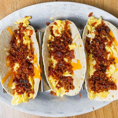 Breakfast TaQos topped with bacon.