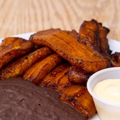 Fried plantains, with beans and cream, closeup