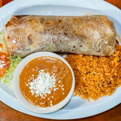 Chimichanga, served with tomato, lettuce, rice, and beans.