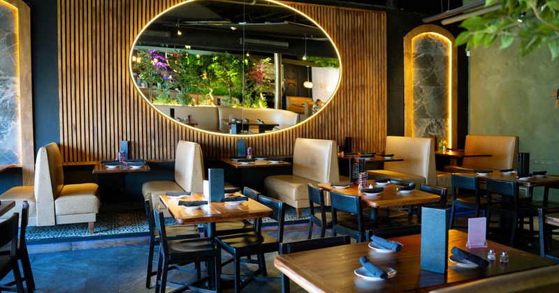 Covered seating area with double booths, organic and neon decoration