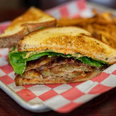 Fried green tomato sandwich and fries.