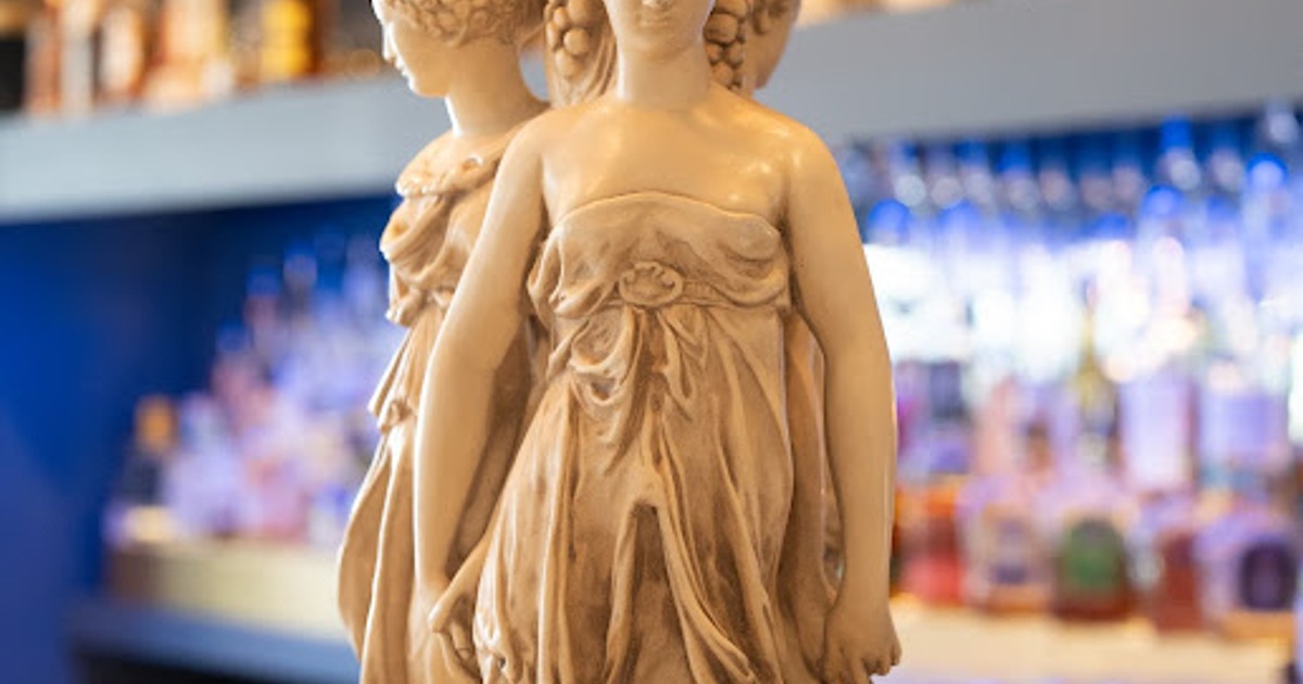 Close-up of a detailed statue depicting two classical female figures