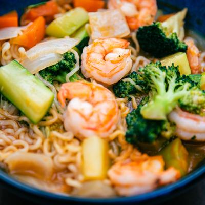 Shrimp stir-fry with noodles and mixed vegetables.