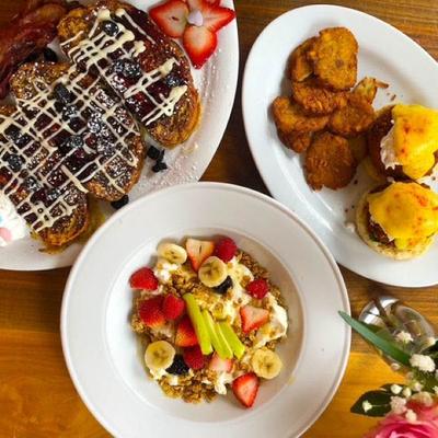 Breakfast plates with granola bowl, French toast, and eggs Benedict.